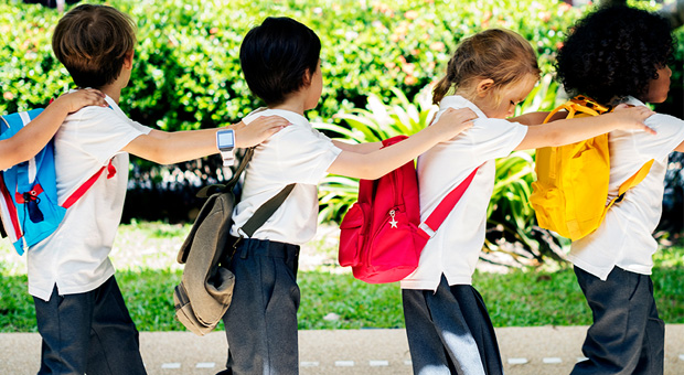 Home to school travel assistance children in a line