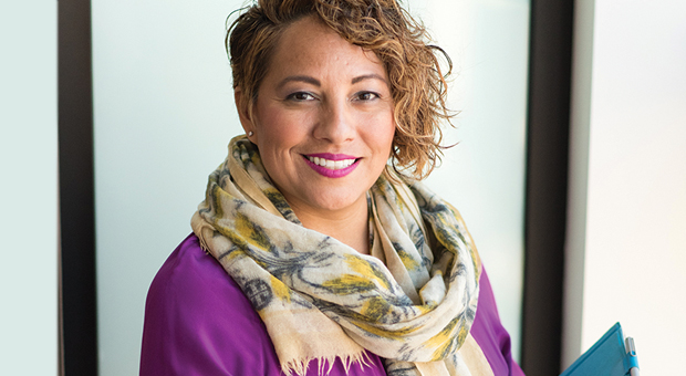 close-up of smartly dressed female employer who is smiling a welcome