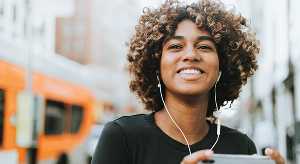 trendy young black woman with earpods 