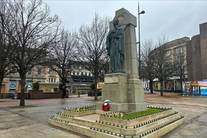 The city centre war memorial with a poppy wreath