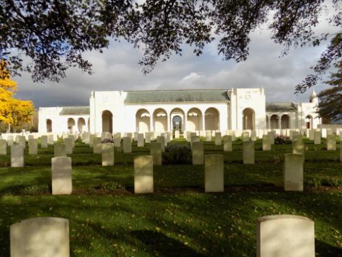 Stone memorial with white gravestones in foreground