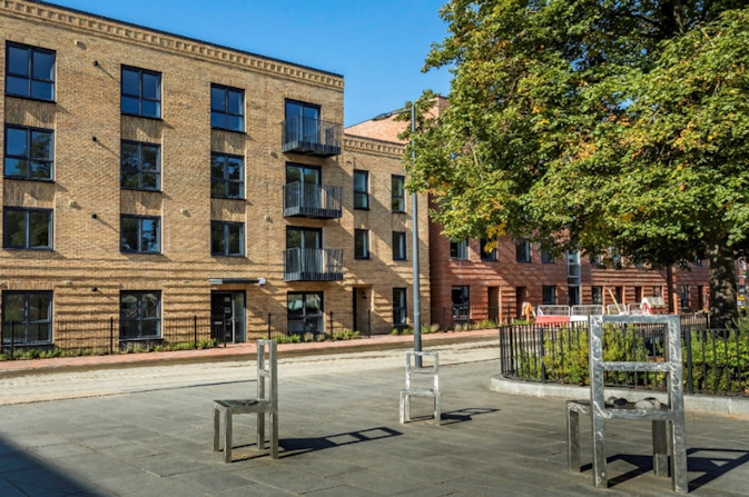 public square in castleward with three chair sculptures.