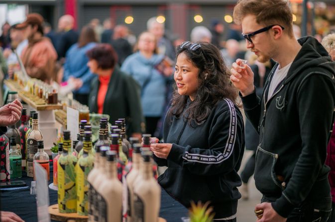 Two young people standing at a market stall