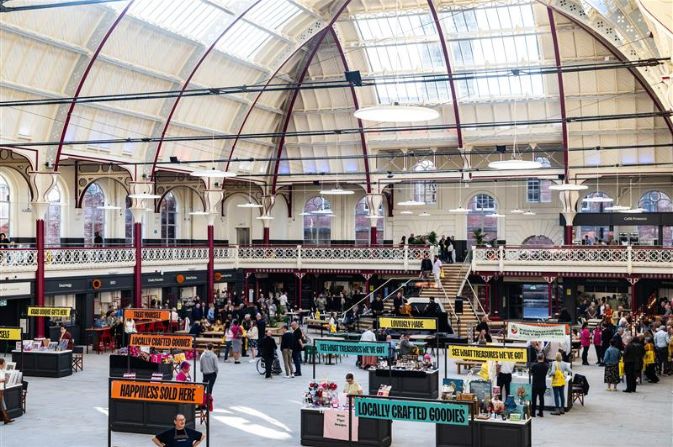 the interior of Derby Market Hall, showing the domed roof and stalls in the central section