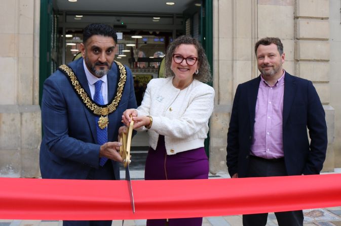 Mayor of Derby Ajit Atwal, Leader of the Council Nadine Peatfield cutting the red ribbon to reopen Derby Market Hall