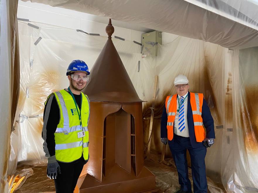 Cllrs Matthew Eyre and Mick Barker with the final finial ready to go back on the roof of the Market Hall. Feb 2022.