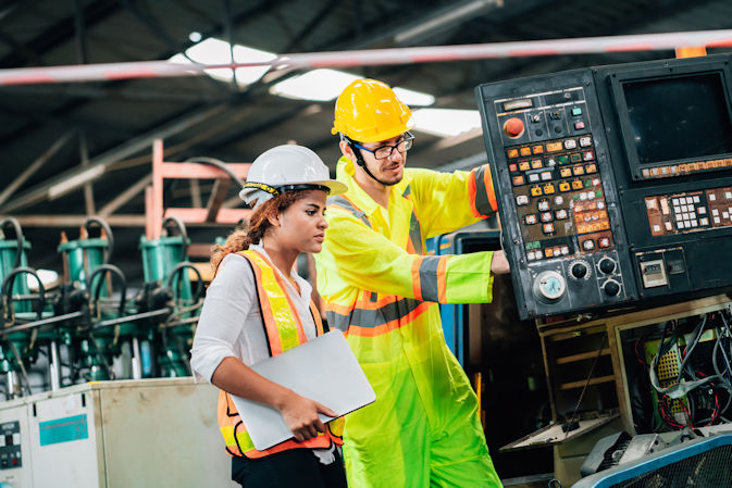 Two people manufacturing a train