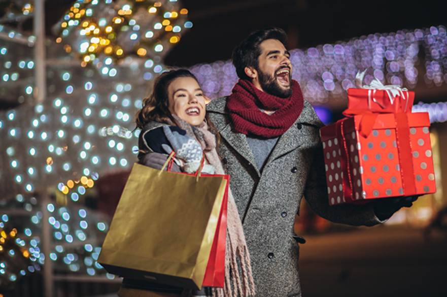 Couple shopping at christmas. Christmas lights.