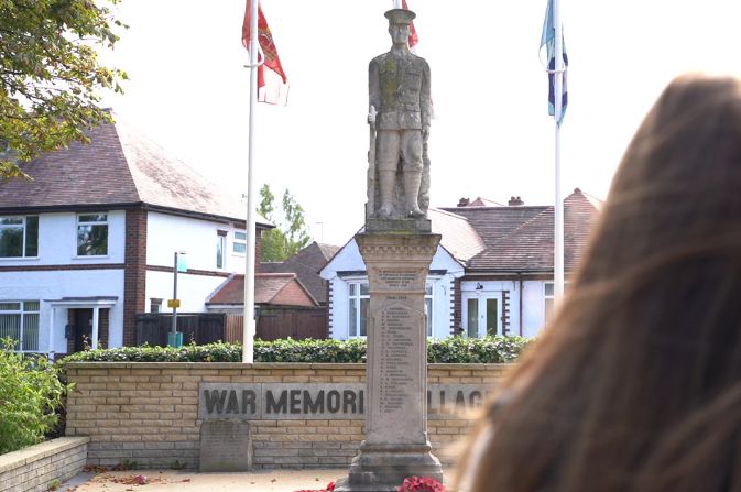 A war memorial with a statue of a soldier on top of a plinth.