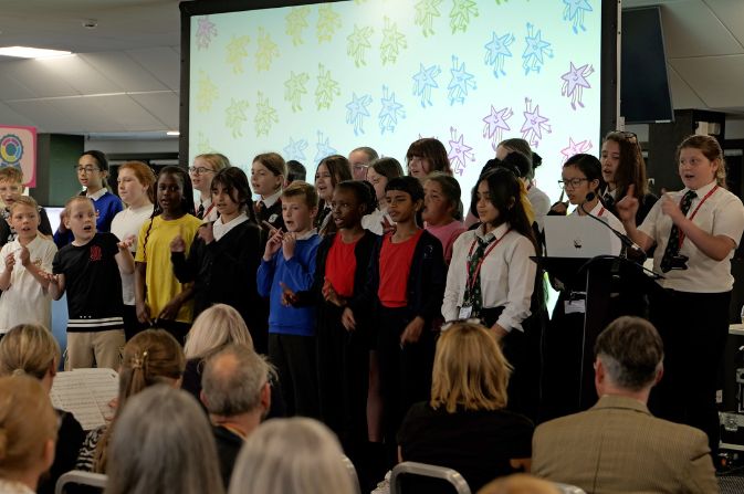 a choir of children singing to an audience