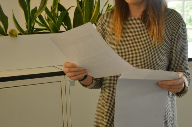 a young woman holding her results sheet