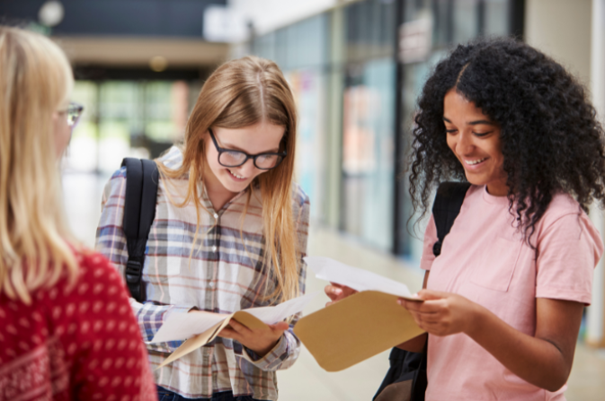 3 young women open exam results