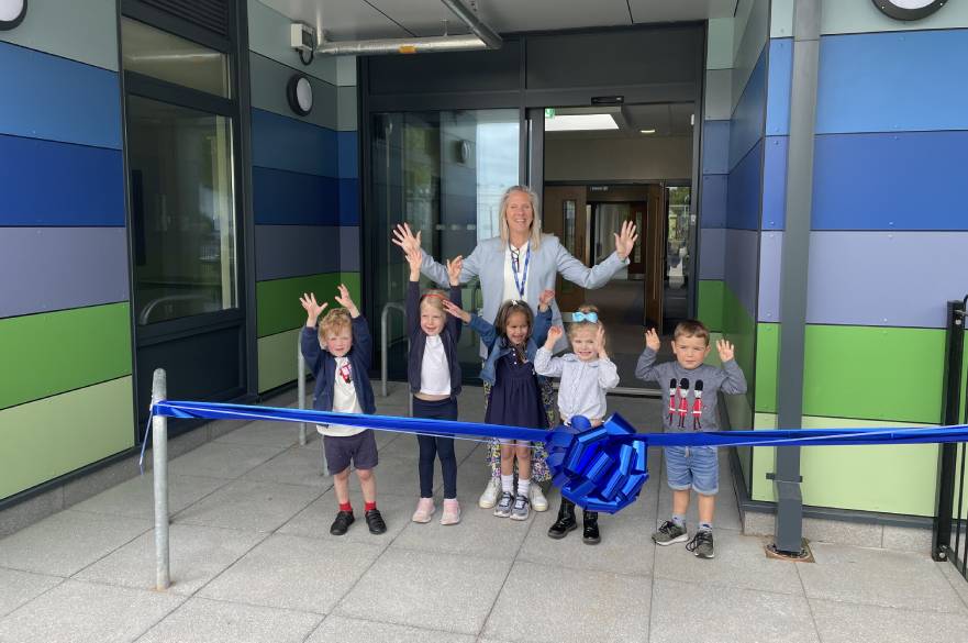 Headteacher Lorna Blanchenot and children celebrate the reopening of Ravensdale Infant and Nursery School in Mickleover