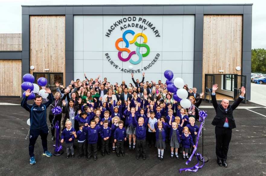 Staff and pupils outside Hackwood Primary school