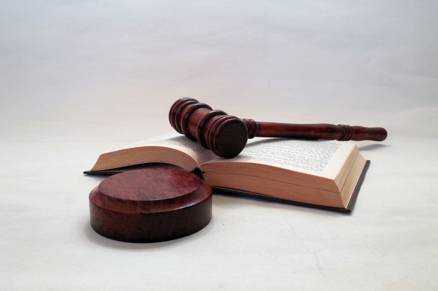Judges gavel on table with open book