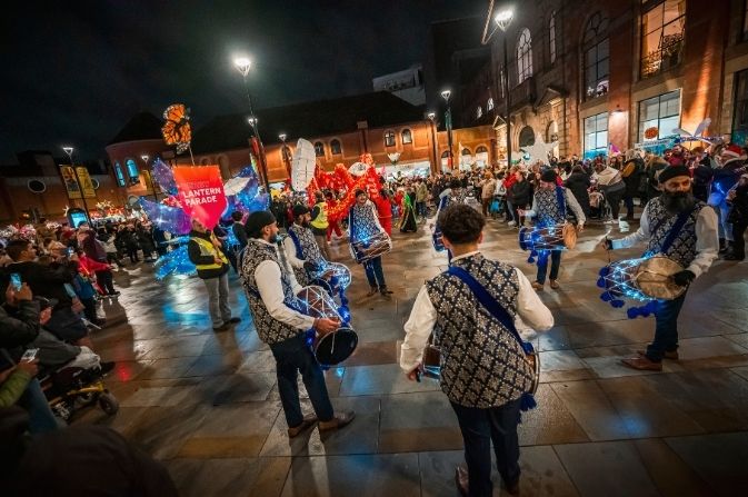 Drummers at the head of the colourful Season of Light Lantern Parade as it moves through Osnabruck Square