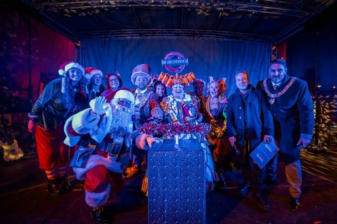 Santa, panto stars, the mayor and Council leader gather around the Christmas Lights plunger