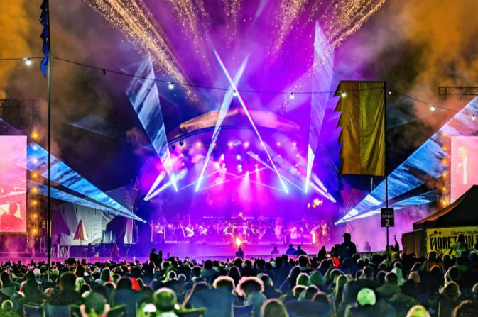 Crowds watch the Darley Park Concert as the stage is lit up with colourful lasers and pyrotechnics