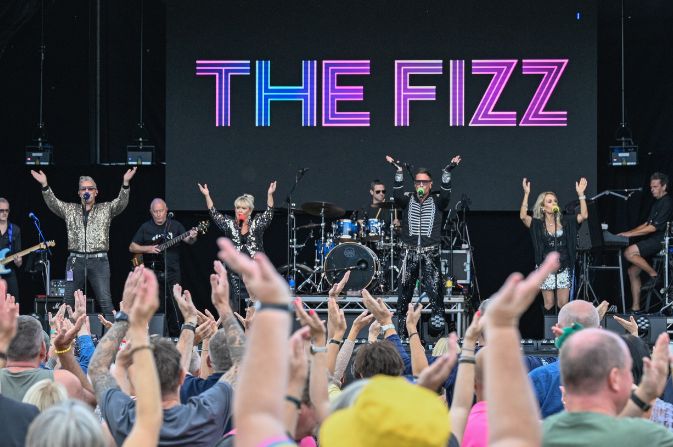 Pop group The Fizz on stage performing in front of a crowd