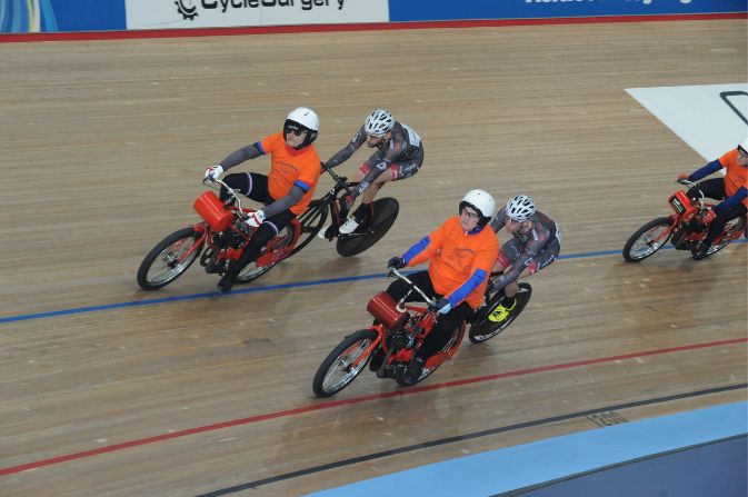 Derny motorbike rider with cyclist on an indoor track