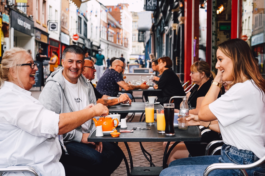 Group of people sat outside a café