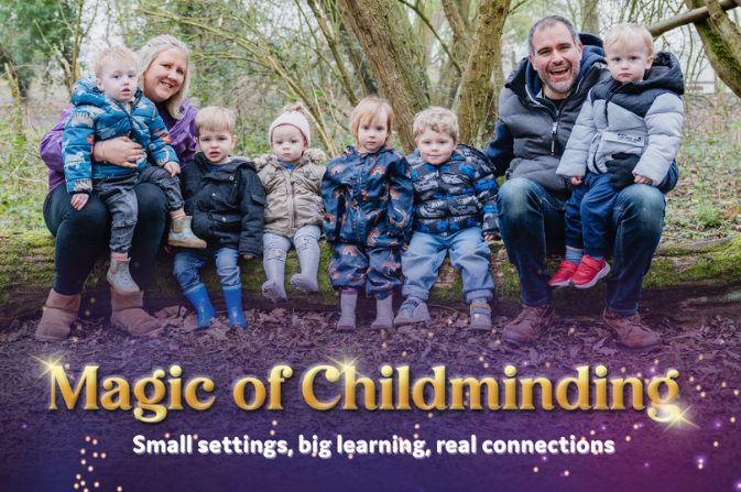 Several children sit with two adults on a log in a forest
