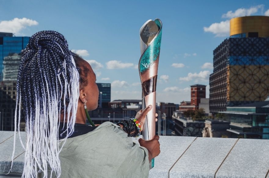 Woman holding Baton outside the central library in Birmingham