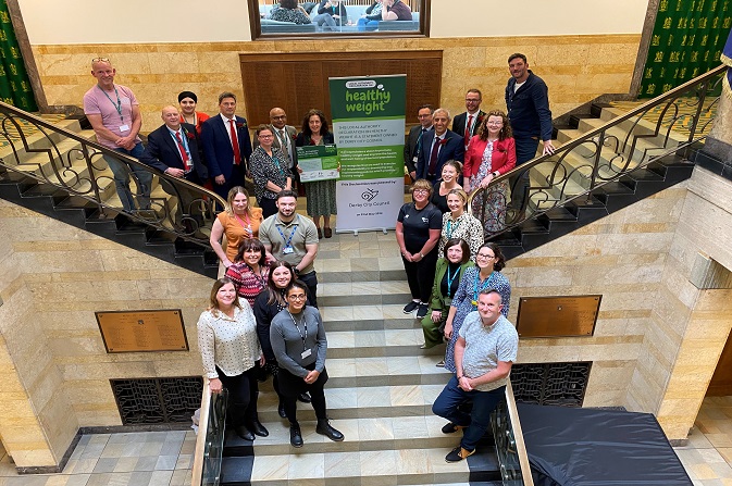 A group gather on the Council House steps to celebrate the signing of the Healthy Weight Declaration
