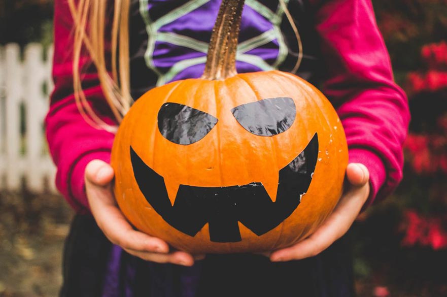 Girl holding halloween pumpkin