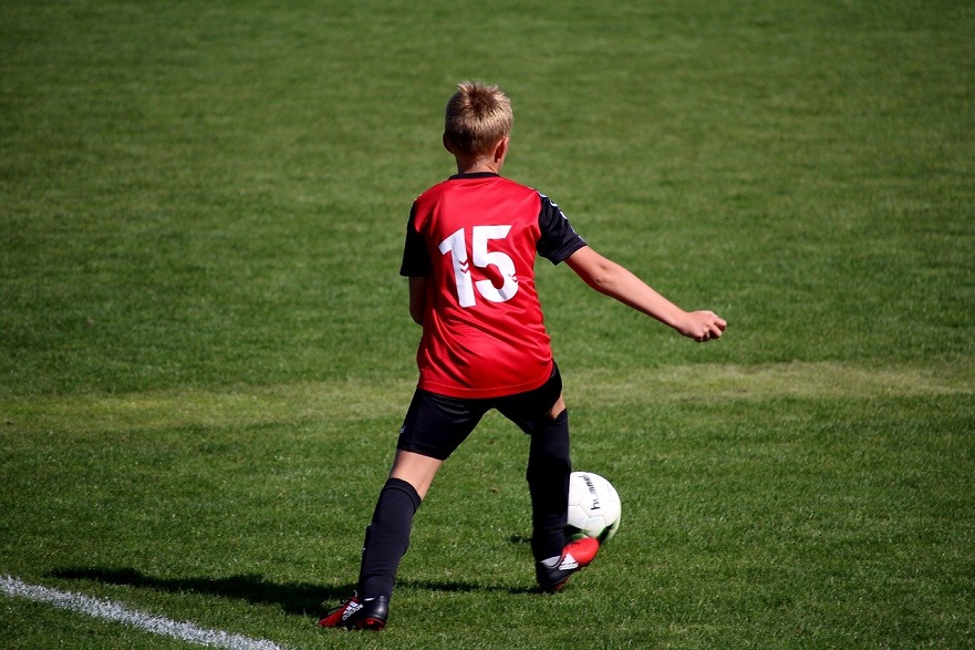 stock picture of boy playing football