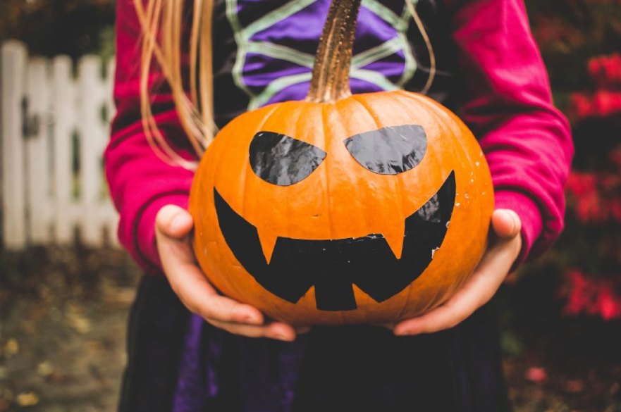 Child holding pumpkin