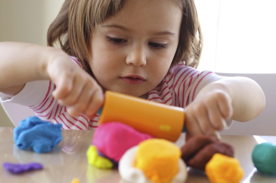 Child playing with plasticine