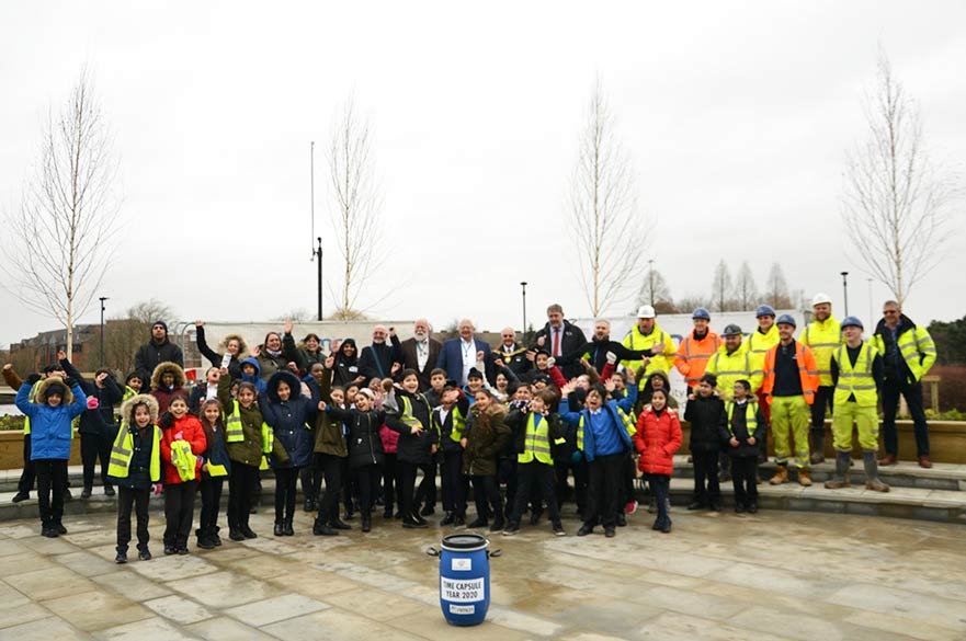 Children and council workers with time capsule