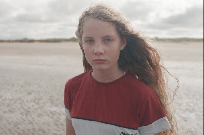 Child on a beach in foster film 2023