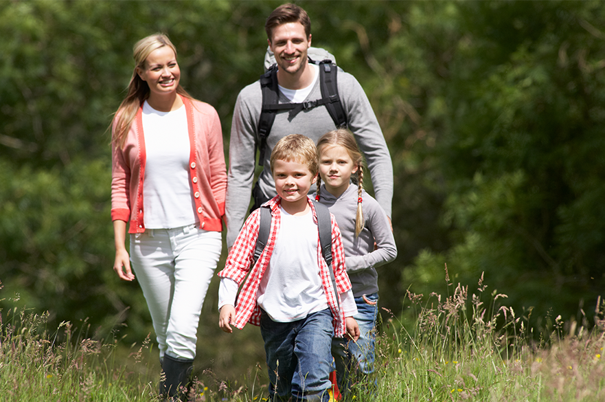 Family walking in a meadow.