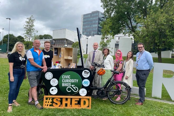 A group of people stood around an eCargo bike