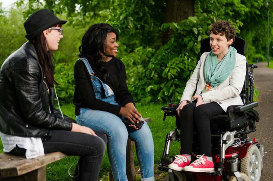 3 girls talking in park