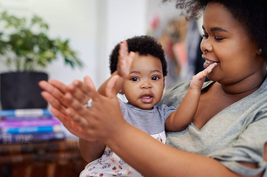 Parent with baby clapping