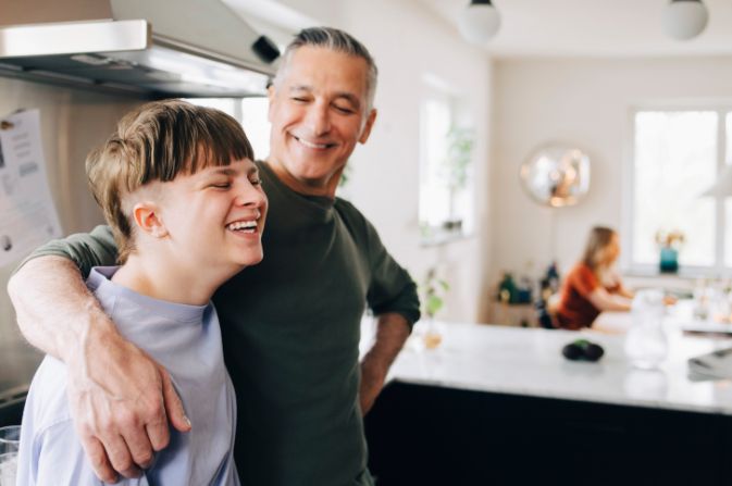 Teenager and a man in a kitchen