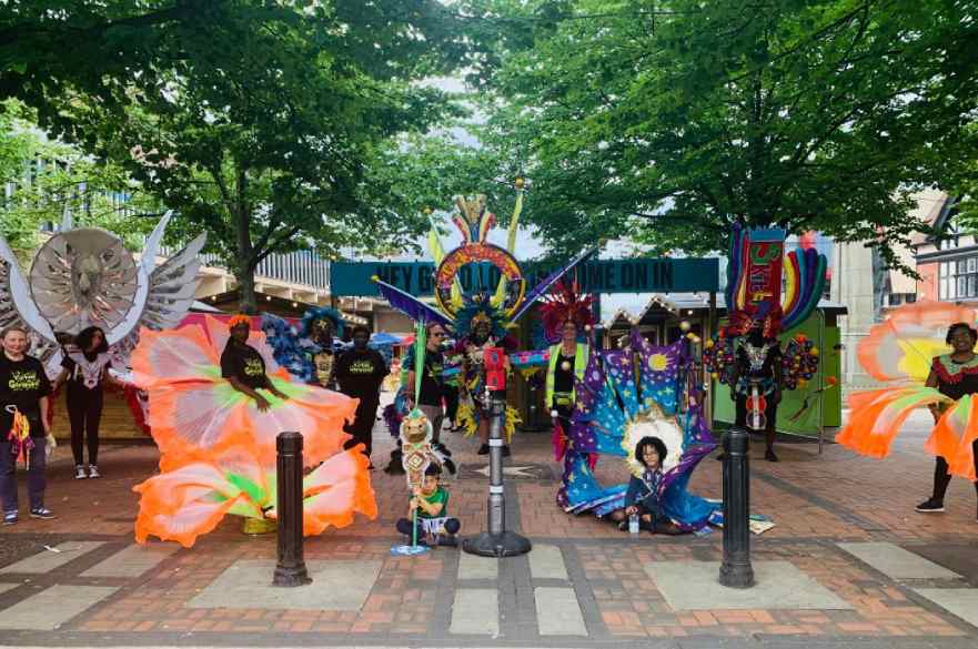 People wearing carnival costumes in Derby Market Place