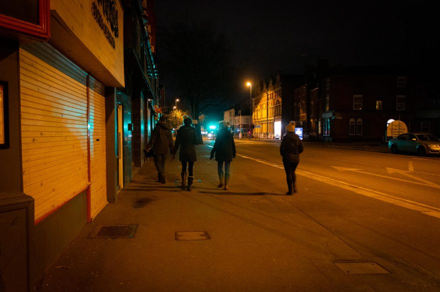 four people walking night