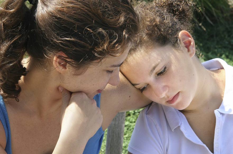 Woman comforting another woman