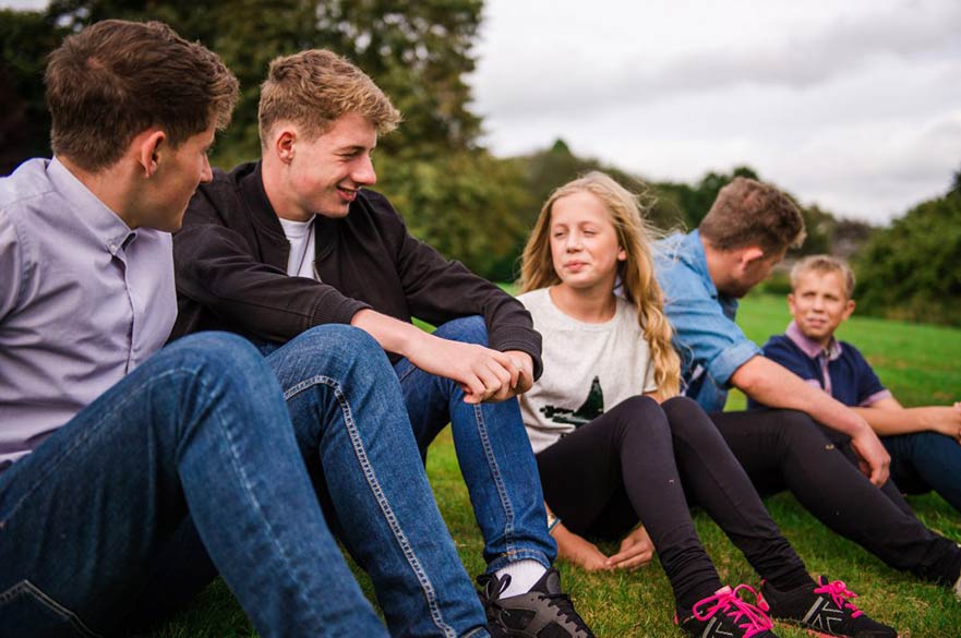 Young people sitting on grass