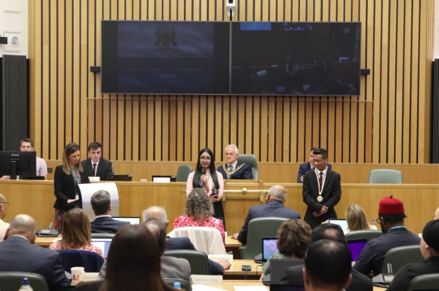 Muhammad Muntasir (right and Harman Kaur (middle) reading their declarations at the Council's AGM on 24 May 2023.