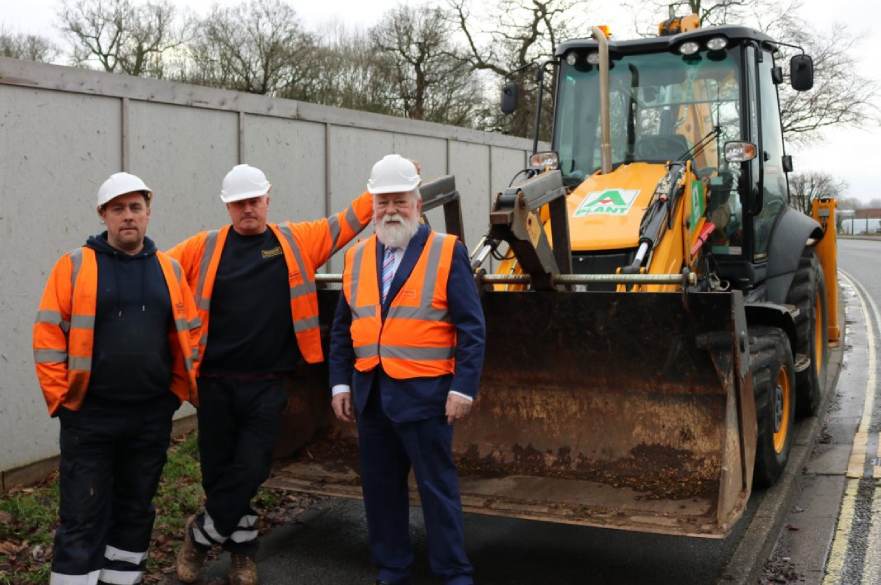 Digger at Moorways with Councillor and construction crew