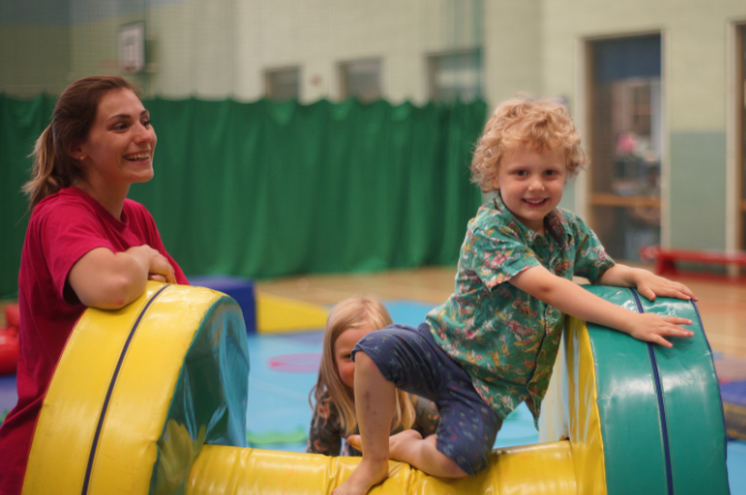 Child climbing over soft play