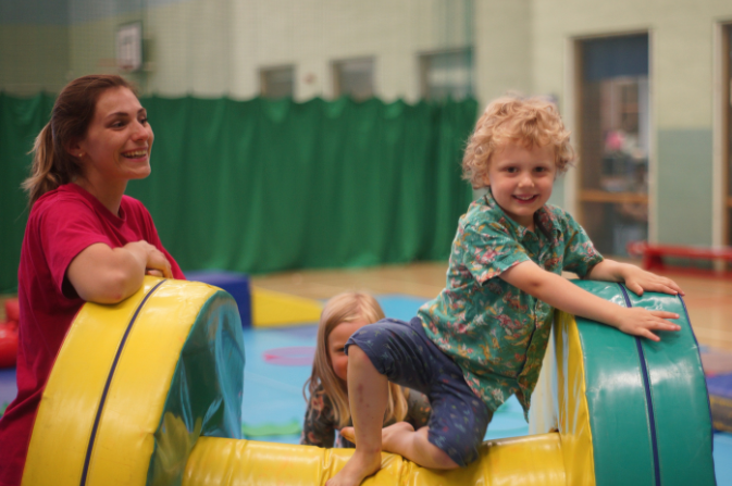 Child climbing over soft play 