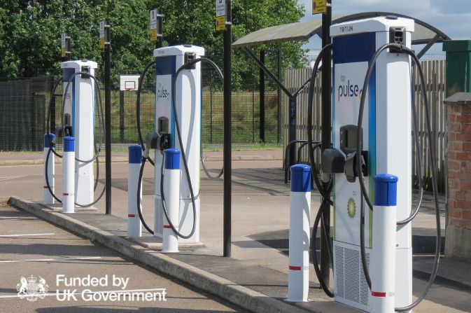A photo of three electric vehicle chargers with bays in a car park