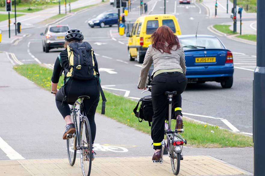 Two people riding bikes