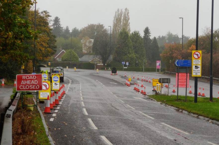 Road with cones and closure signs